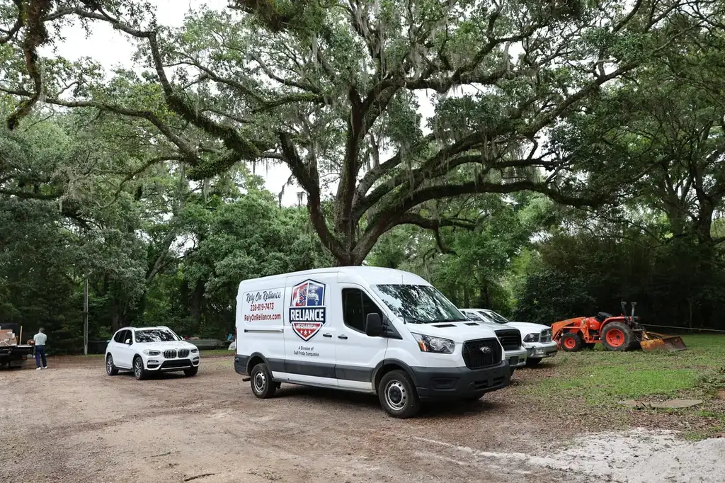Reliance Mechanical service van parked under live oaks on the Mississippi Gulf Coast