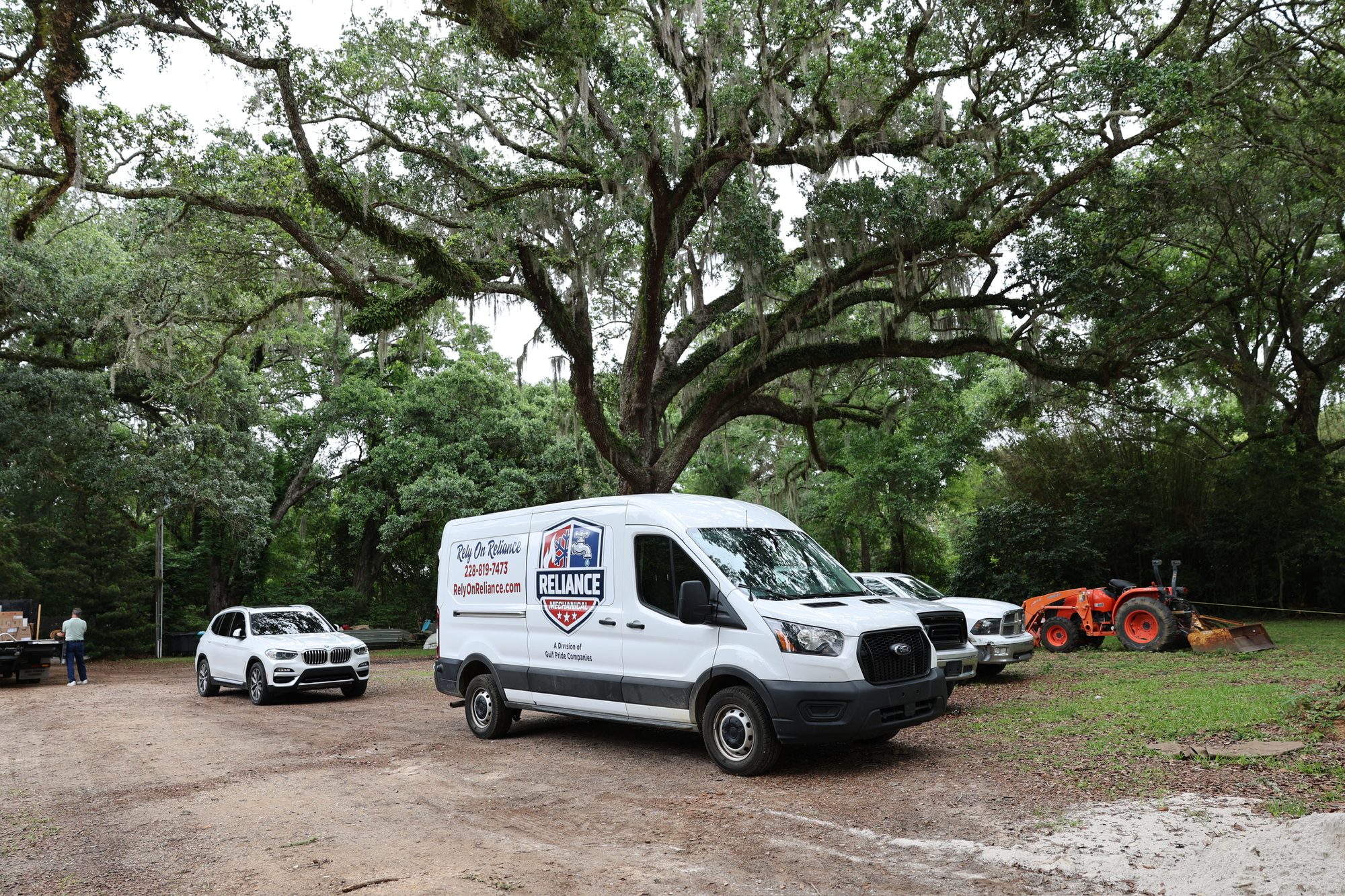 Reliance Mechanical service van parked under live oaks on the Mississippi Gulf Coast