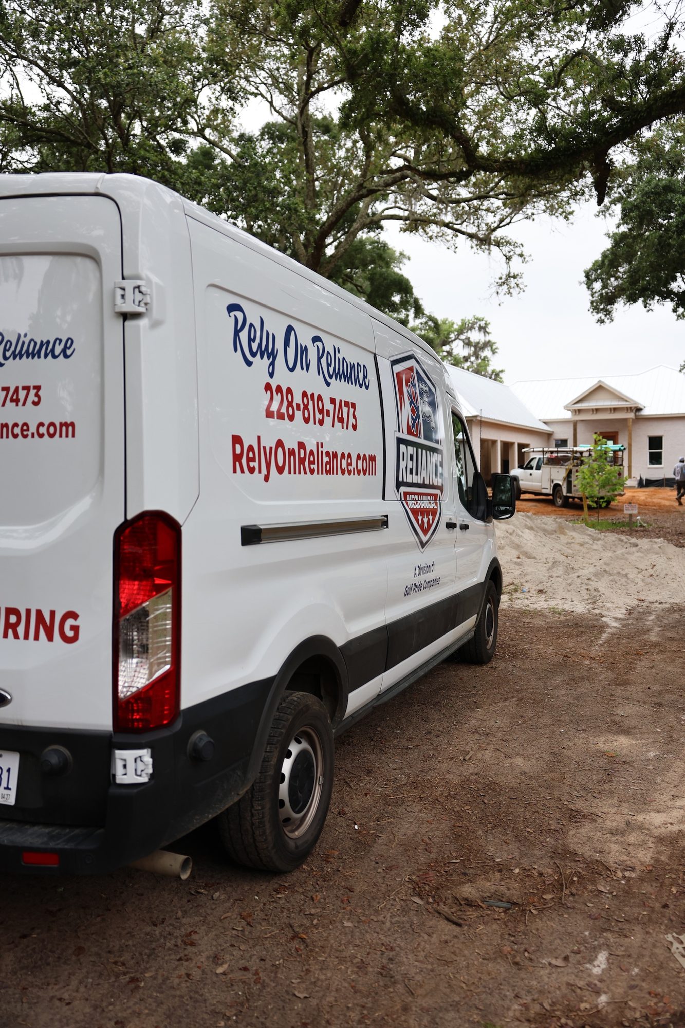 Reliance Mechanical service van at a new-construction home on the Mississippi Gulf Coast