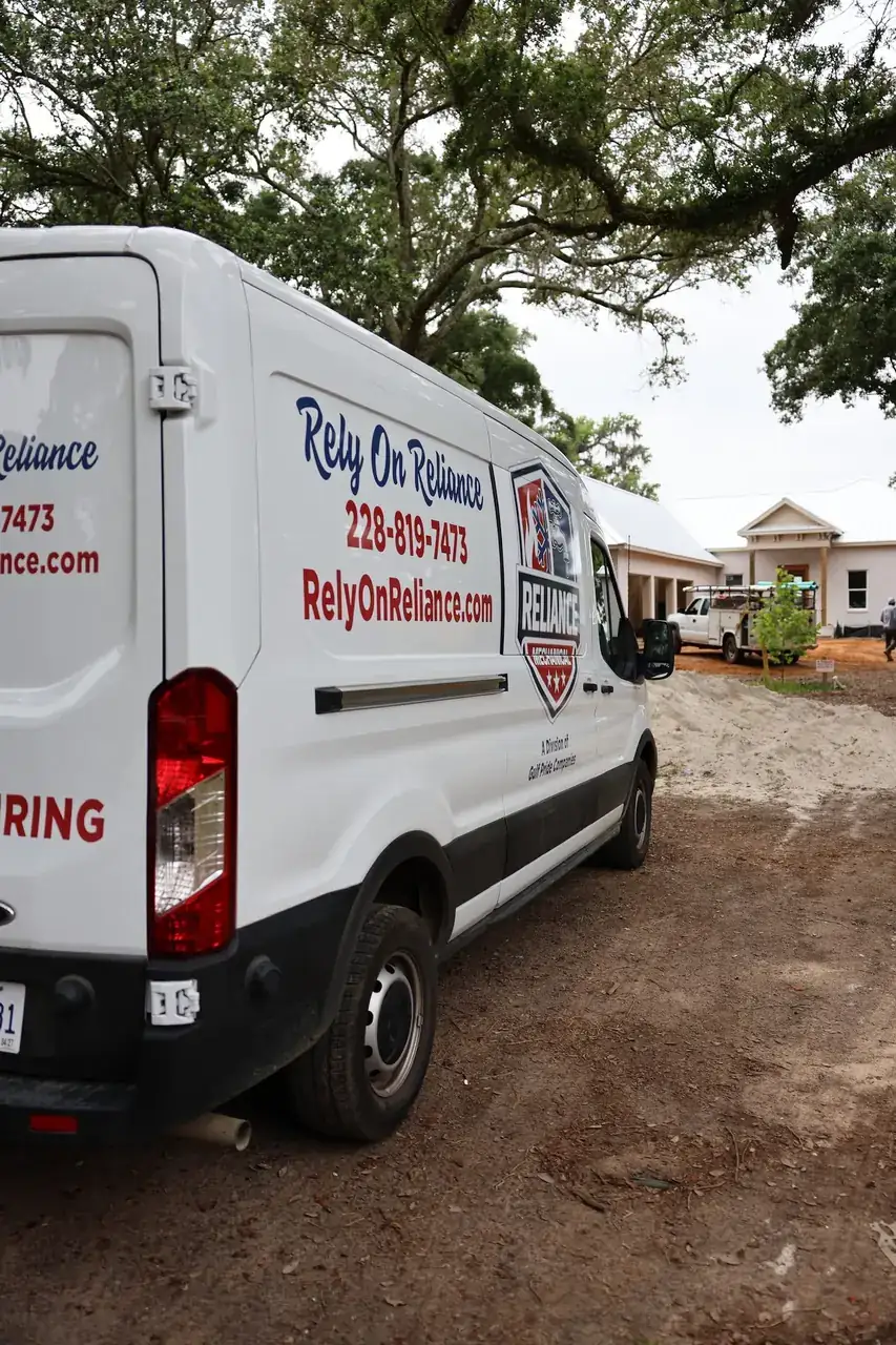 Reliance Mechanical service van at a new-construction home on the Mississippi Gulf Coast